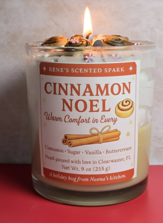 Cinnamon Noel candle with cinnamon roll decorations and festive label, hand-poured by René’s Scented Spark in Clearwater, FL.