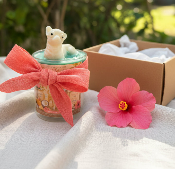 candle with a pink bow with a chihuahua mold on top