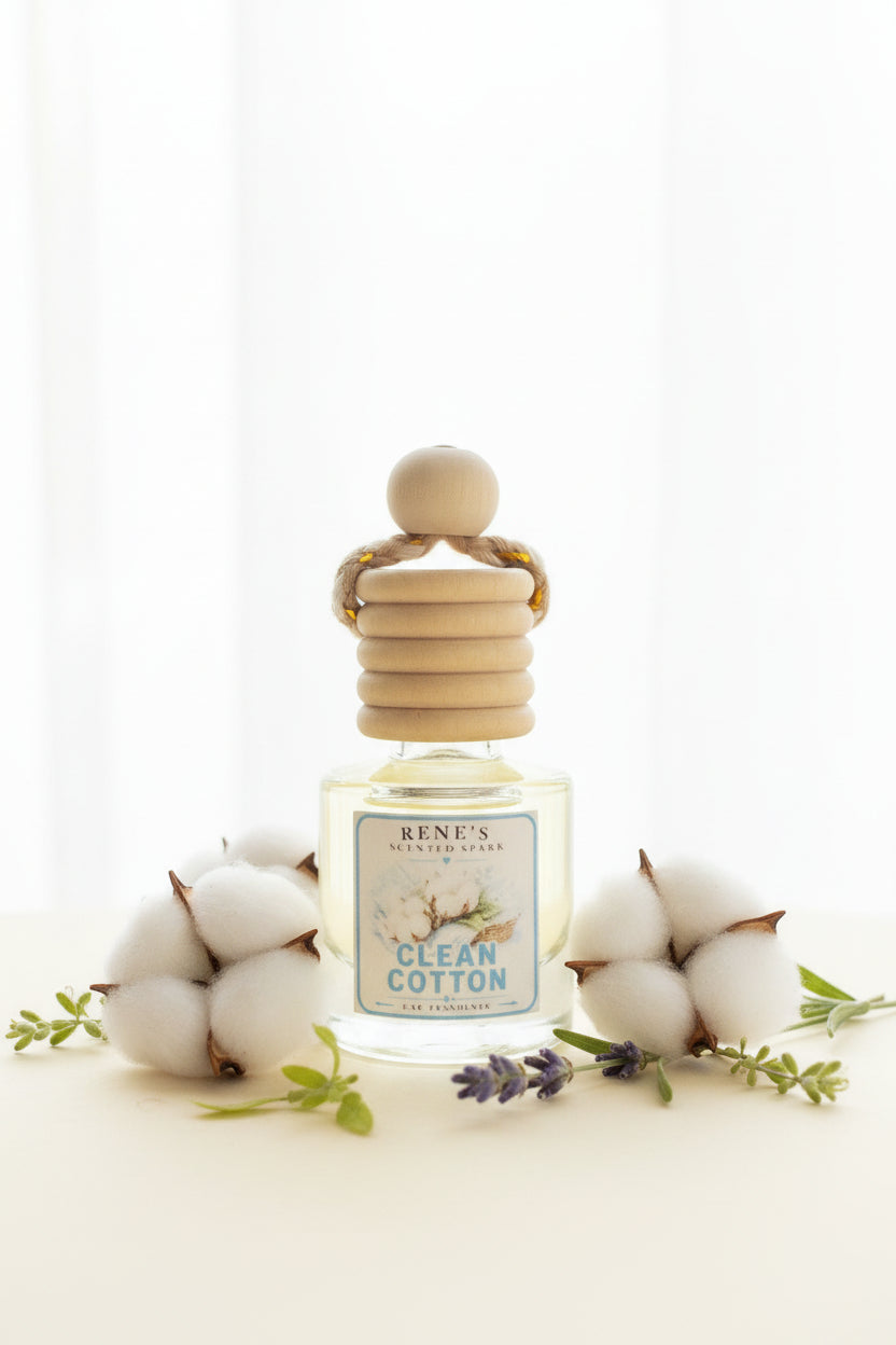Clean Cotton hanging car air freshener by Rene’s Scented Spark displayed with soft white cotton blossoms, lavender sprigs, and fresh greenery against a bright neutral background.