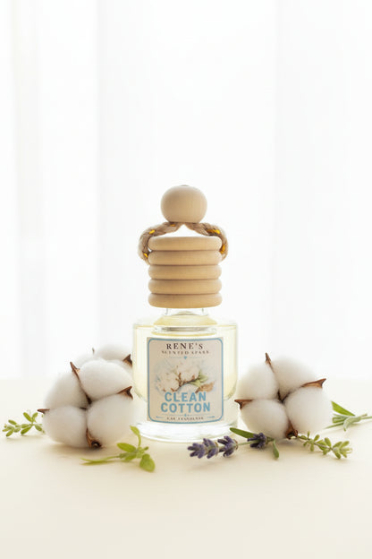 Clean Cotton hanging car air freshener by Rene’s Scented Spark displayed with soft white cotton blossoms, lavender sprigs, and fresh greenery against a bright neutral background.