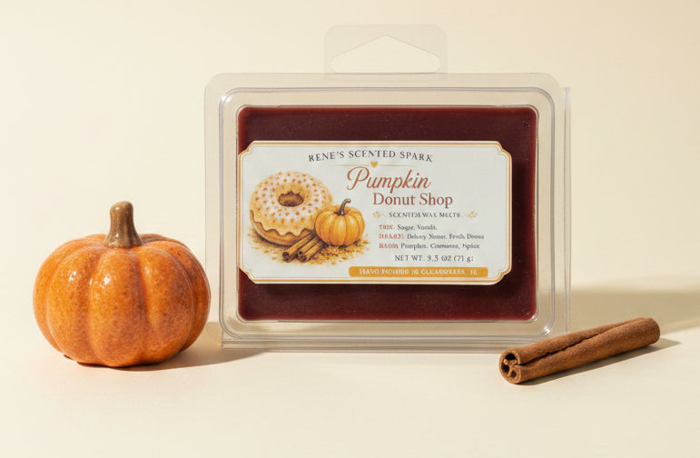 Pumpkin Donut Shop 2.5 oz scented wax melts displayed with a small orange pumpkin and cinnamon stick on a warm cream background.