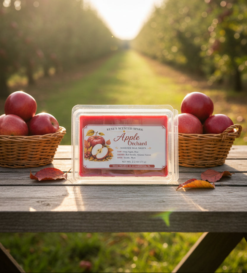 Apple Orchard 2.5 oz scented wax melts displayed on a rustic wooden table between baskets of red apples in a sunlit autumn apple orchard