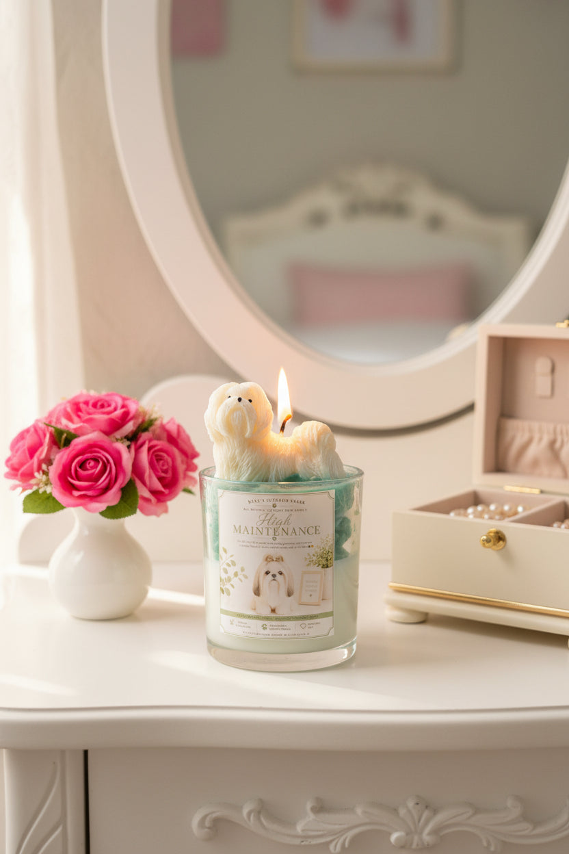 High Maintenance candle with white Shih Tzu wax topper on teal green wax on white vanity with pink roses