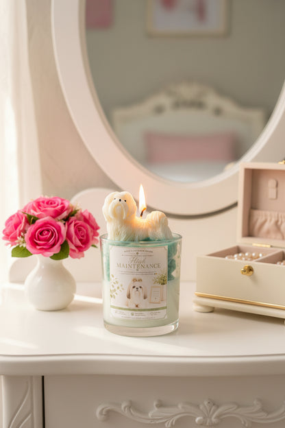 High Maintenance candle with white Shih Tzu wax topper on teal green wax on white vanity with pink roses
