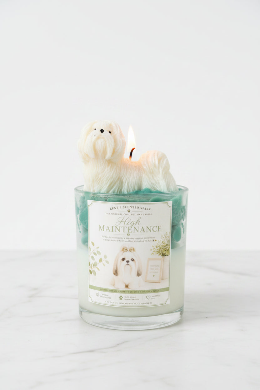 Two High Maintenance Shih Tzu candles with teal green whipped wax and white dog toppers on outdoor marble surface