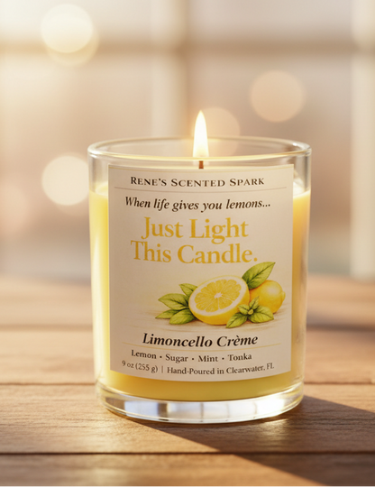 Limoncello Crème yellow coconut wax candle with lemon-themed label surrounded by fresh lemons and green leaves