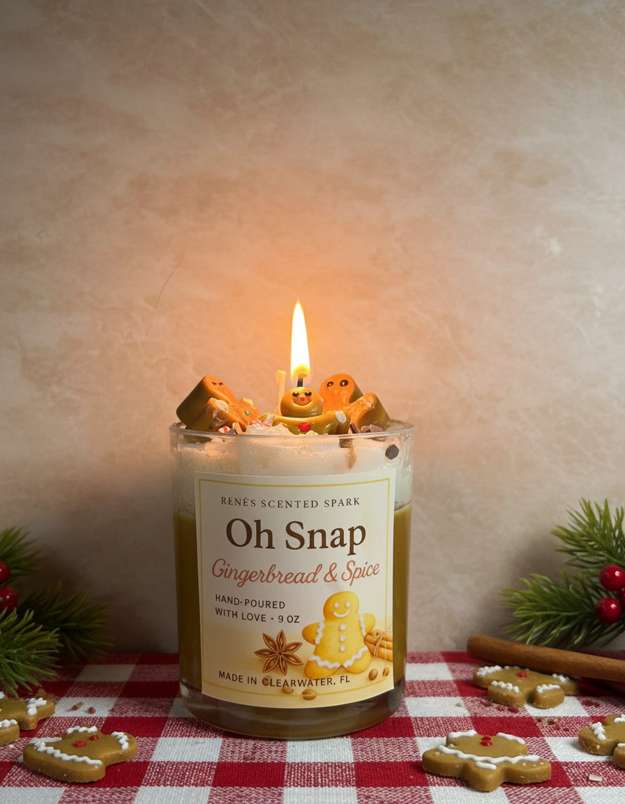 Candle labeled 'Oh Snap Gingerbread & Spice' with gingerbread cookies on a kitchen counter.