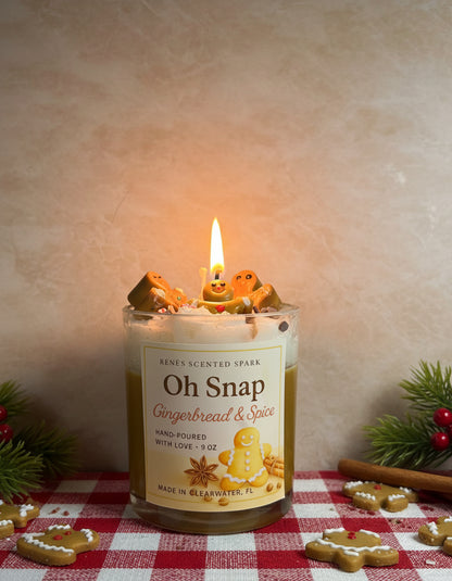 Candle labeled 'Oh Snap Gingerbread & Spice' with gingerbread cookies on a kitchen counter.