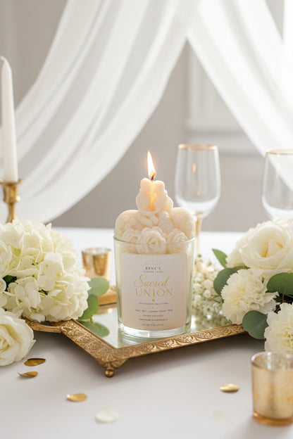 Sacred Union wedding candle displayed on ornate gold tray with white florals and romantic reception-inspired décor