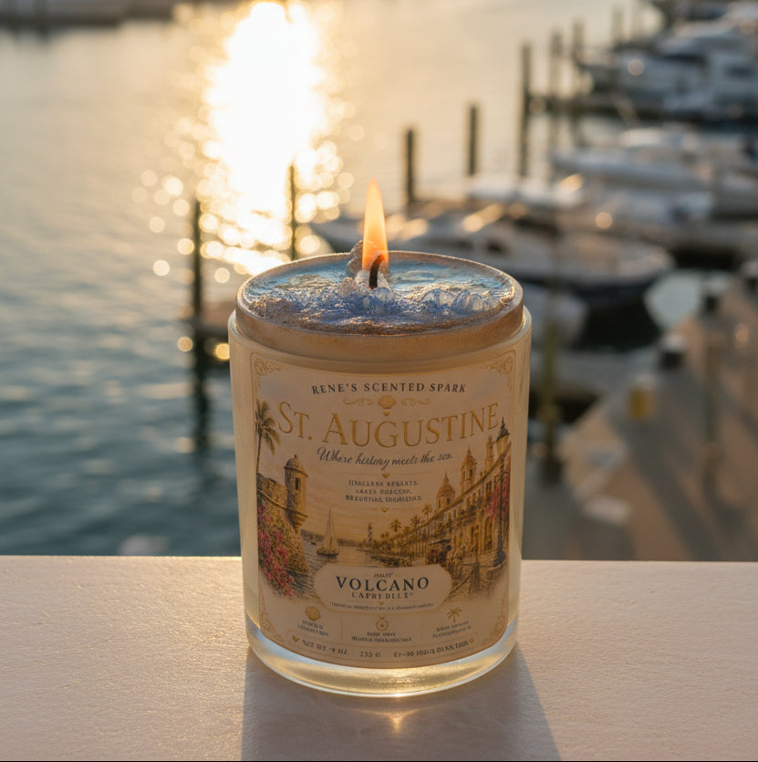 Lit St. Augustine coconut wax candle by Rene's Scented Spark displayed overlooking a marina at sunset, featuring a vintage Florida-inspired label and hand-poured glass jar.
