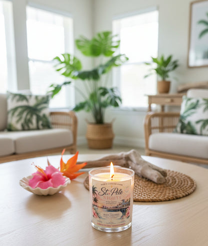 Lit St. Pete Nights Black Coconut coconut wax candle by Rene's Scented Spark on a bedside table beside an open book and reading glasses, creating a warm and relaxing bedroom atmosphere.