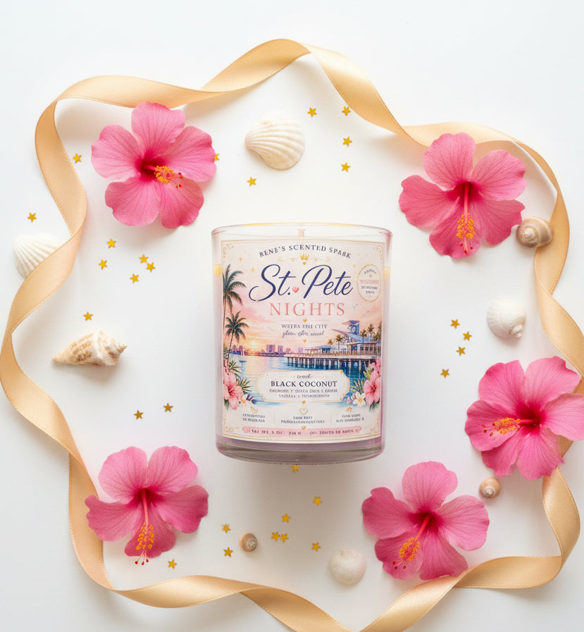 Candle on a white background with pink tropical flowers and seashells
