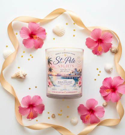 Candle on a white background with pink tropical flowers and seashells