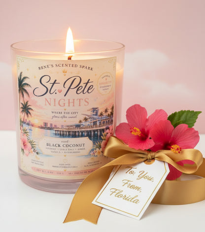 Candle labeled 'St. Pete Nights' with a decorative bow and tag on a light pink background