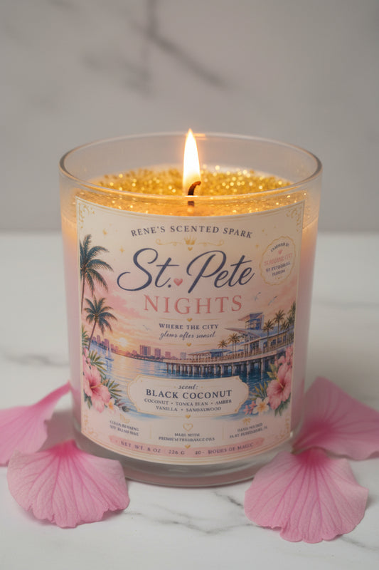 Candle labeled 'St. Pete Nights' with decorative design on a light blue background