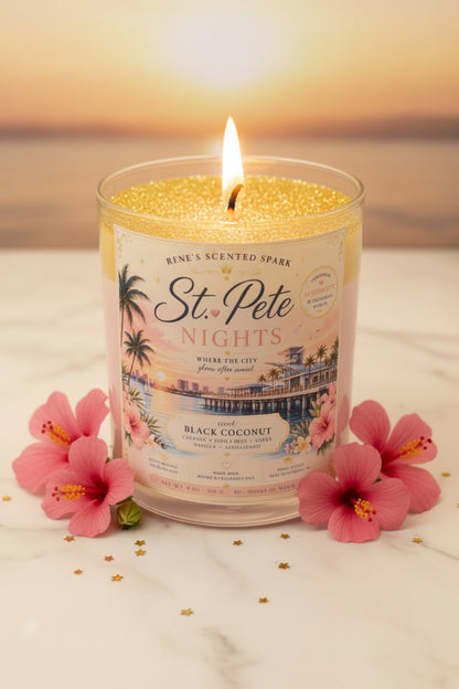 Candle labeled 'St. Pete Nights' with pink flowers on a light background