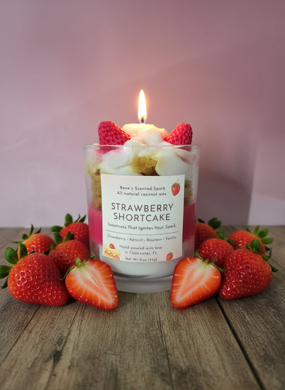 Strawberry Shortcake candle with strawberries on a wooden surface