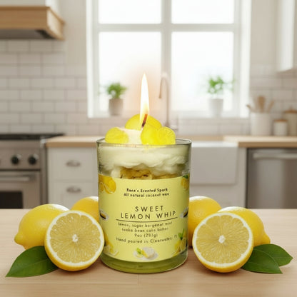 Sweet Lemon Whip candle glowing on a kitchen counter beside lemons.