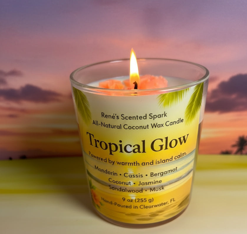 Lit Tropical Glow coconut wax candle featuring a palm-inspired label and glowing sunset backdrop.