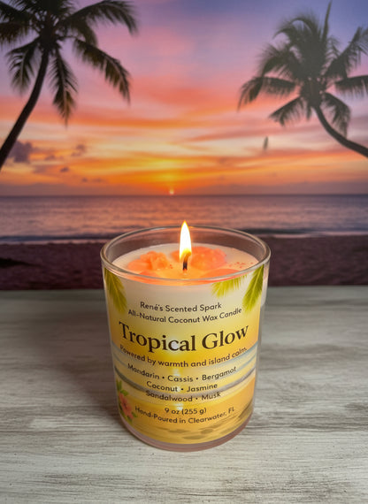Lit Tropical Glow coconut wax candle featuring a palm-inspired label and glowing sunset backdrop.