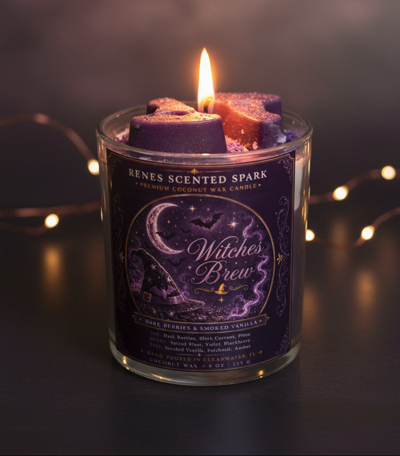 Witches Brew Halloween coconut wax candle glowing in a dark moody setting with purple witch hat wax toppers and warm fairy lights in the background.