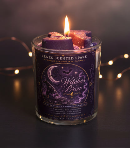 Witches Brew Halloween coconut wax candle glowing in a dark moody setting with purple witch hat wax toppers and warm fairy lights in the background.