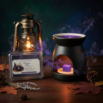 Witches Brew purple wax melts by Rene’s Scented Spark beside a black wax warmer with a melting purple wax cube, glowing lantern, lavender, and autumn leaves.