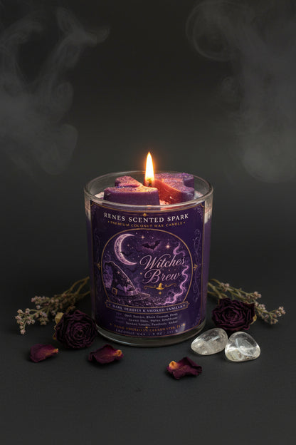 Witches Brew Halloween coconut wax candle glowing against a dark smoky background with dried purple roses, botanicals, and clear crystals.