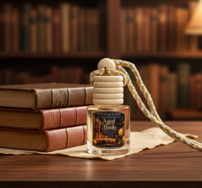Aged Books car freshener by Renes Scented Spark with a wooden diffuser cap beside vintage leather-bound books in a warm cozy library setting.