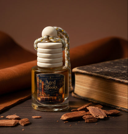 Aged Books car freshener by Renes Scented Spark displayed beside a vintage book and warm wood accents, featuring a wooden diffuser cap and rich old-library inspired styling.