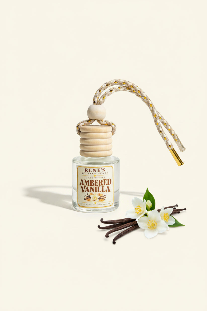 Ambered Vanilla car freshener by Rene’s Scented Spark displayed on a clean cream background with vanilla beans and delicate white flowers.