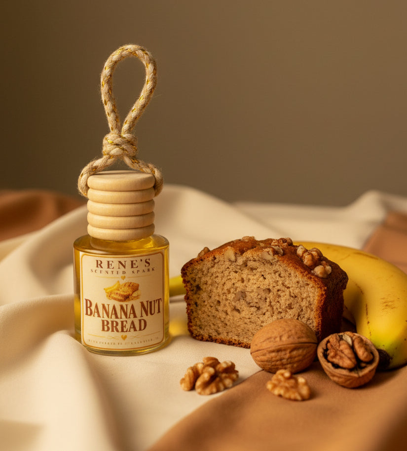 : Banana Nut Bread hanging car air freshener by Rene’s Scented Spark displayed beside fresh banana bread, ripe banana, and walnuts on warm cream and caramel fabric. 🍌🤎