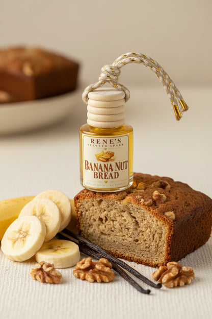 Banana Nut Bread hanging car air freshener by Rene’s Scented Spark displayed with freshly baked banana bread, sliced bananas, walnuts, and vanilla beans in a warm neutral setting.