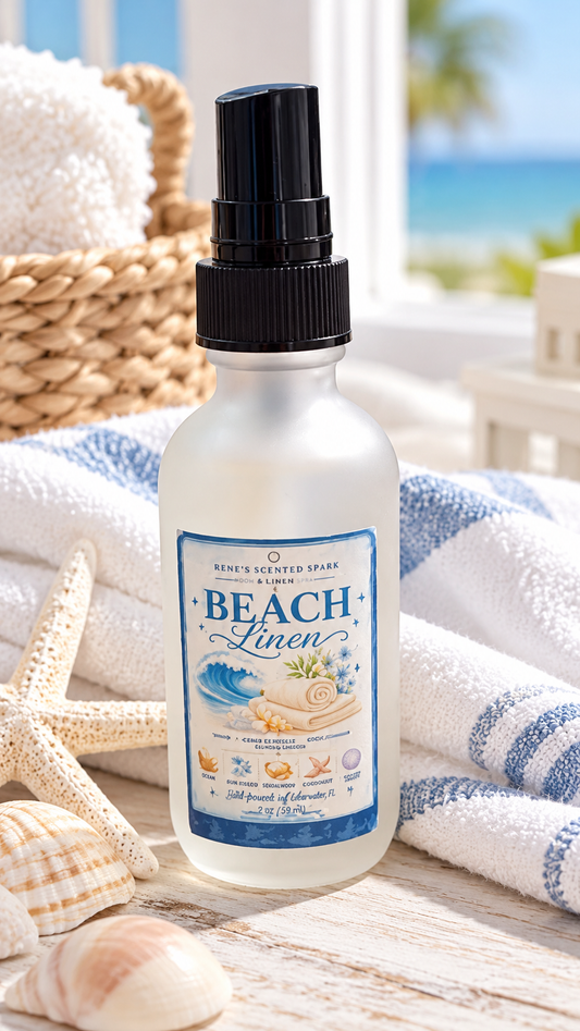 Rene's Scented Spark Beach Linen 2 oz room and linen spray in frosted glass bottle with blue coastal label, beside folded striped towels, a starfish, and a woven basket