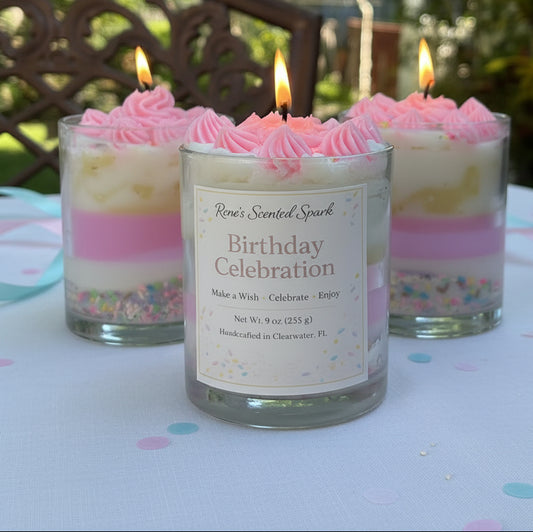 Birthday Celebration coconut wax candles with pink frosting tops and sprinkles, three lit candles in festive setting