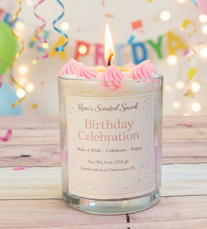 Birthday-themed candle with pink frosting and a 'Rene's Scented Spark' label, set against a festive background.