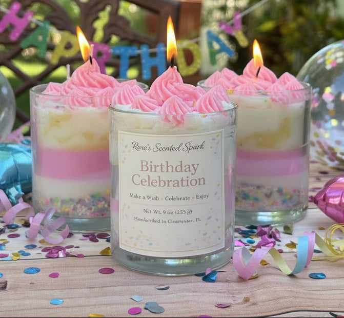 Birthday Celebration coconut wax candles with pink frosting tops and sprinkles, three lit candles in festive setting