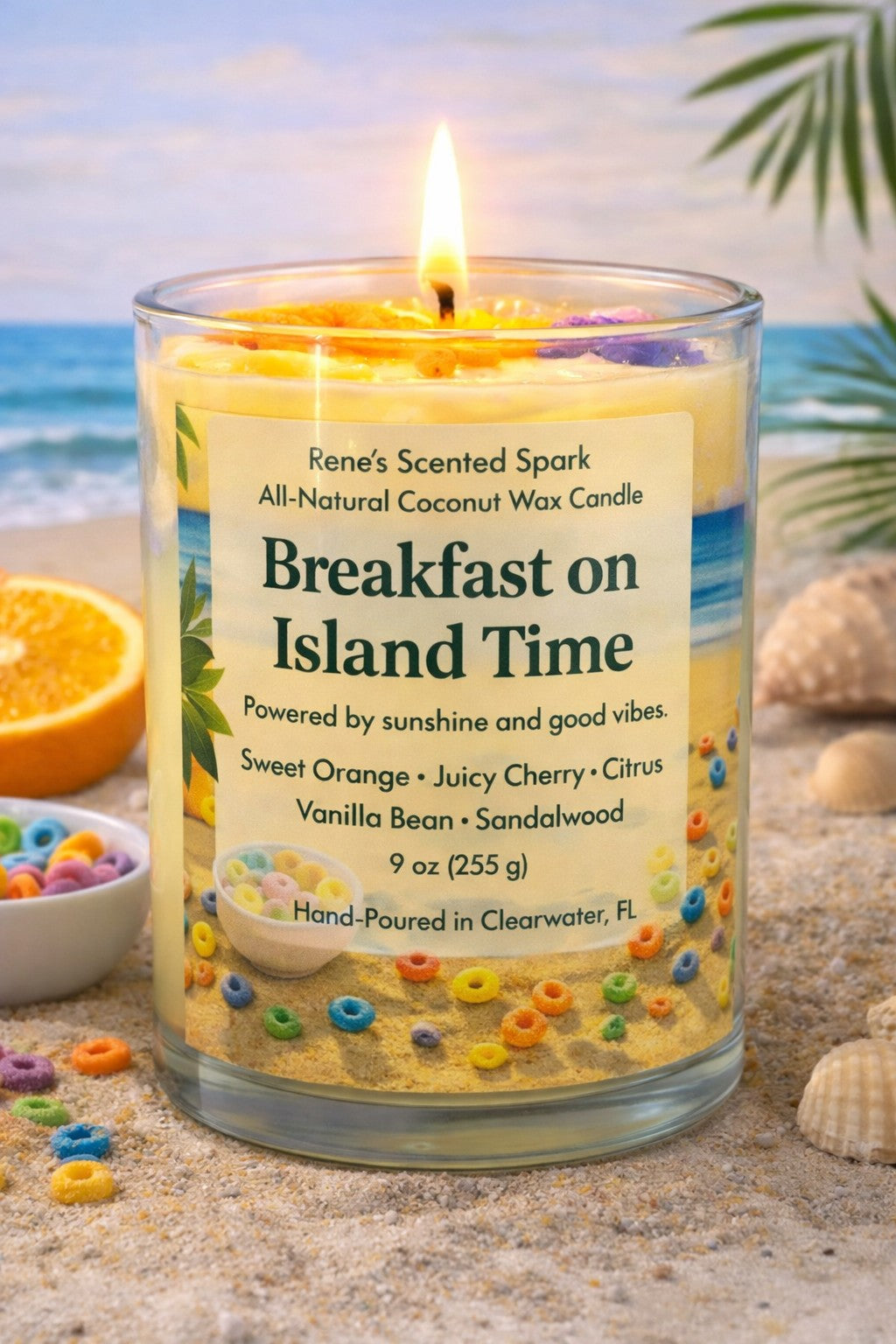 Breakfast on Island Time all-natural coconut wax candle lit in a clear glass jar, featuring colorful cereal-inspired wax embeds and a tropical beach label, 9 oz