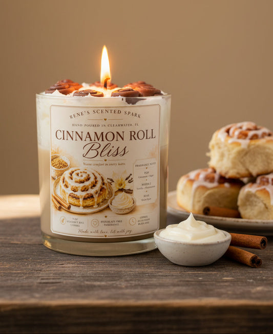 Candle labeled 'Cinnamon Roll Bliss' by Rene's Scented Spark on a wooden surface.