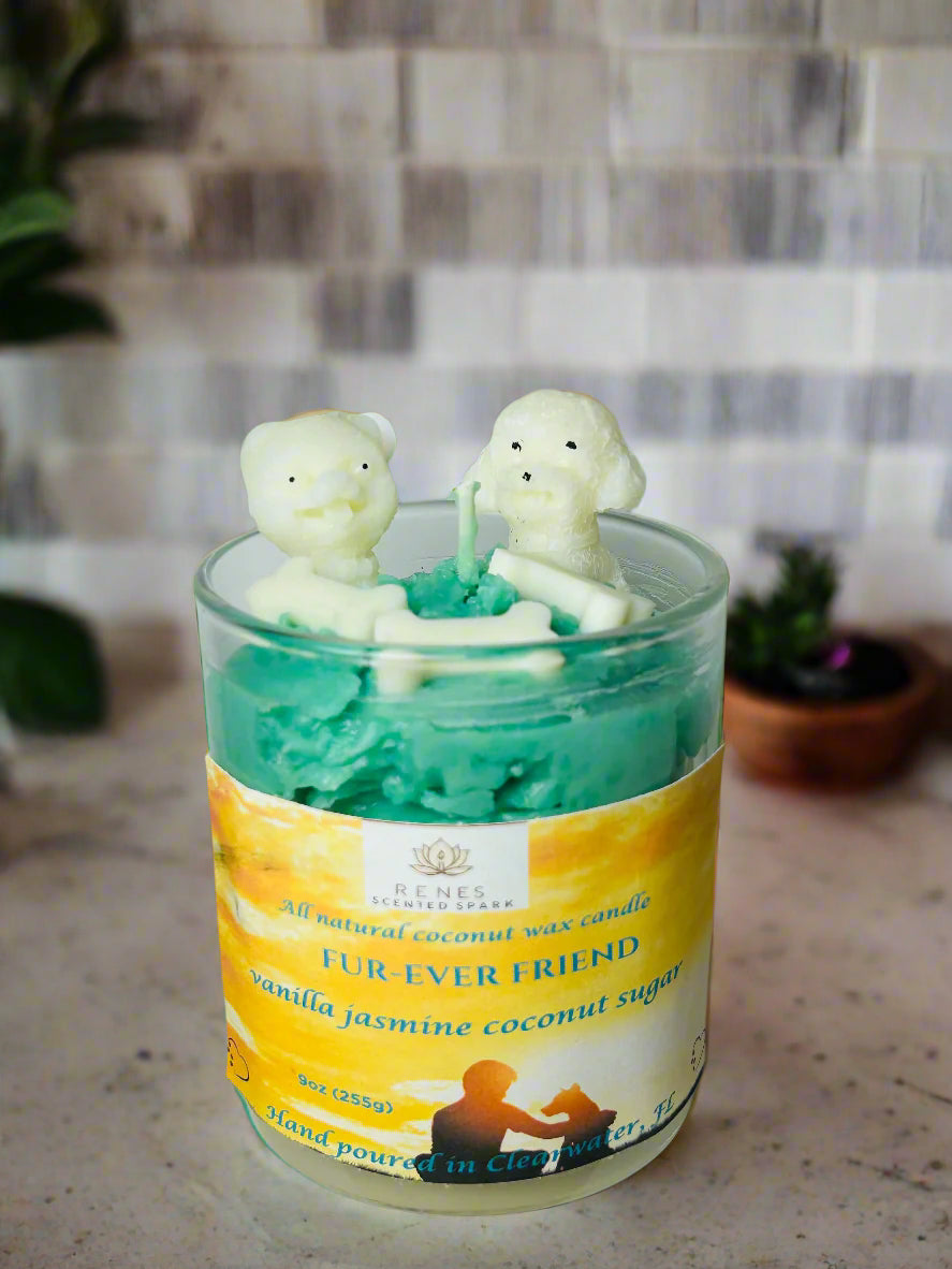 Fur-Ever Friend candle with teal coconut wax topped with two white dog-shaped molds and bone embeds, infused with warm vanilla — gift for dog lovers