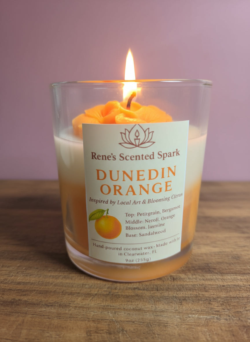 Hand-poured Dunedin Orange candle by Rene’s Scented Spark, featuring a vibrant orange rose top and locally inspired label, made in Clearwater, Florida.