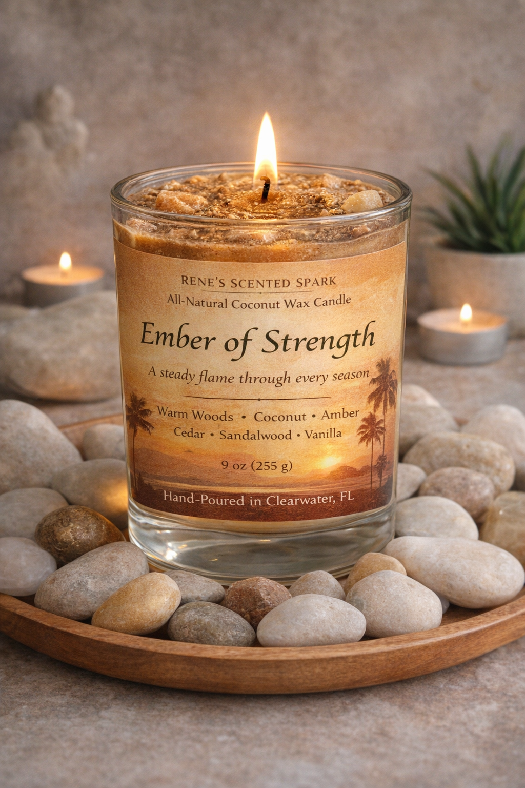 Candle labeled 'Ember of Strength' on a stone surface with a blurred background