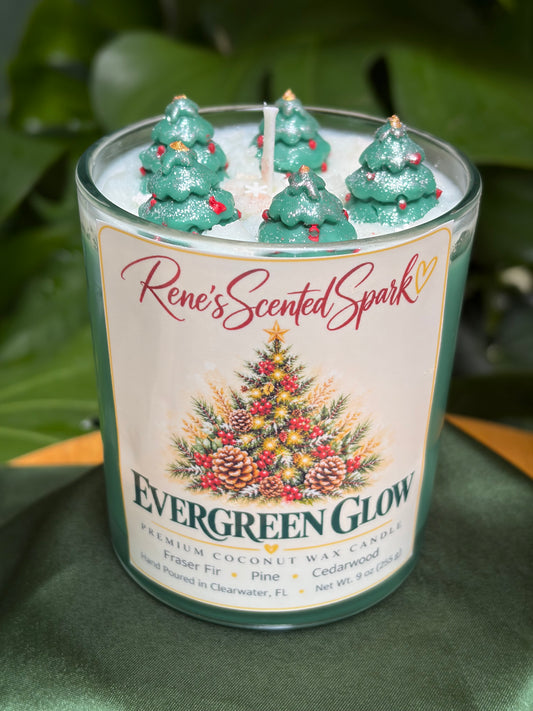 Evergreen Glow Christmas candle with green coconut wax, snowy white top and handmade wax Christmas tree toppers in a clear glass jar