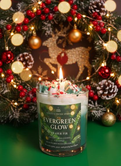 Candle labeled 'Evergreen Glow' in front of a decorated Christmas tree with lights and ornaments.