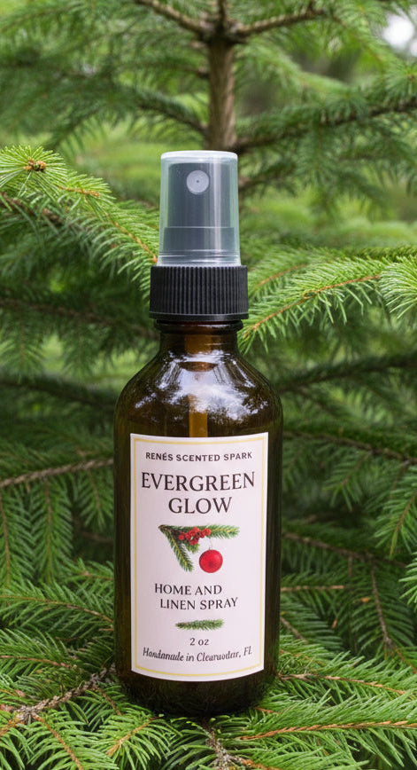 Amber glass bottle labeled “Evergreen Glow Home & Linen Spray” by René’s Scented Spark, displayed in front of a pine tree