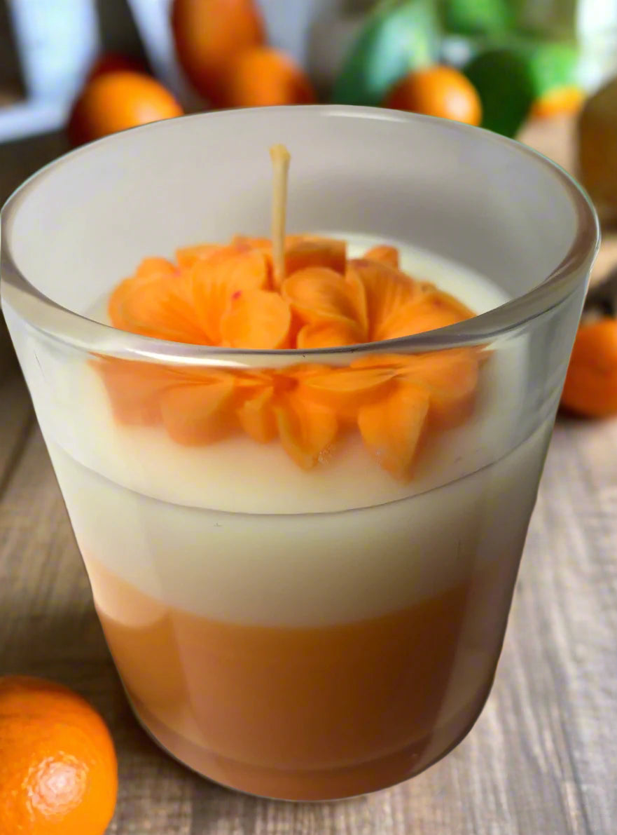 Handcrafted Dunedin Orange candle in gift-ready packaging, citrus blossom design with orange and white wax, inspired by Dunedin art