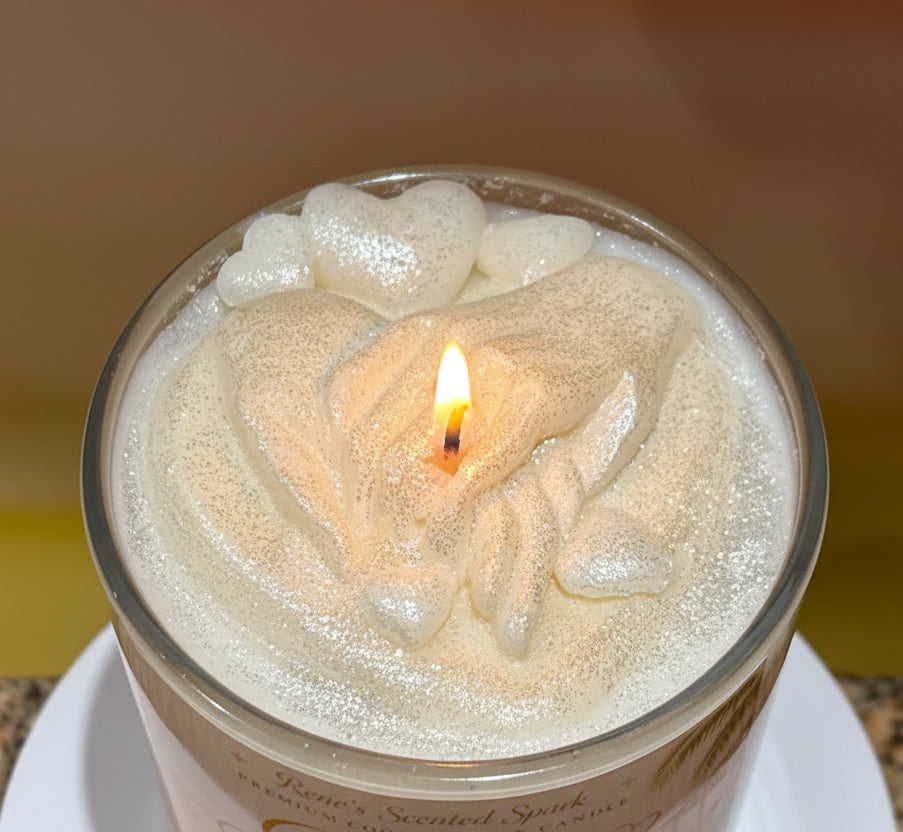 Candle labeled 'Golden Beginnings' with clasped hands and hearts on the top of the candle