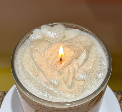 Candle labeled 'Golden Beginnings' with clasped hands and hearts on the top of the candle