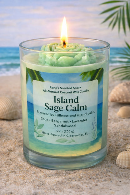 Candle labeled 'Island Sage Calm' on a beach with ocean and palm leaves in the background