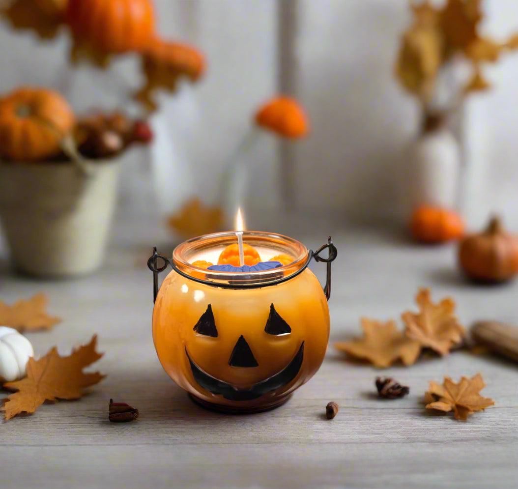 Jack’s Spiced Lantern candle glowing on a cozy autumn table with pumpkins, leaves, and warm décor — pumpkin spice fall candle gift